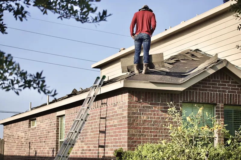Professional roofer working on a residential roof in Los Banos